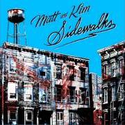 Le texte musical CAMERAS de MATT & KIM est également présent dans l'album Sidewalks (2010)